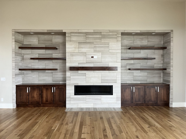 Floor-to-ceiling tile fireplace by RMC Tile